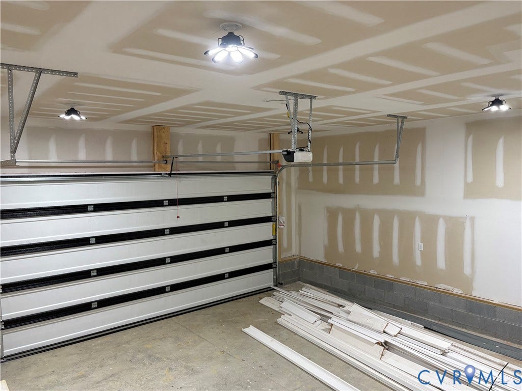 15135 Lebanon, Parson's Retreat, Disputanta, VA 23842 Attached two-car garage featuring a sectional overhead door, automated door opener, and multiple overhead LED light fixtures