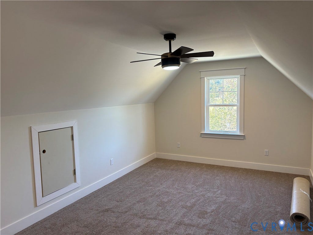 15135 Lebanon, Parson's Retreat, Disputanta, VA 23842 Interior room featuring vaulted ceilings, neutral-toned carpeting, a single-hung window with casing, and a multi-blade ceiling fan with an integrated light fixture