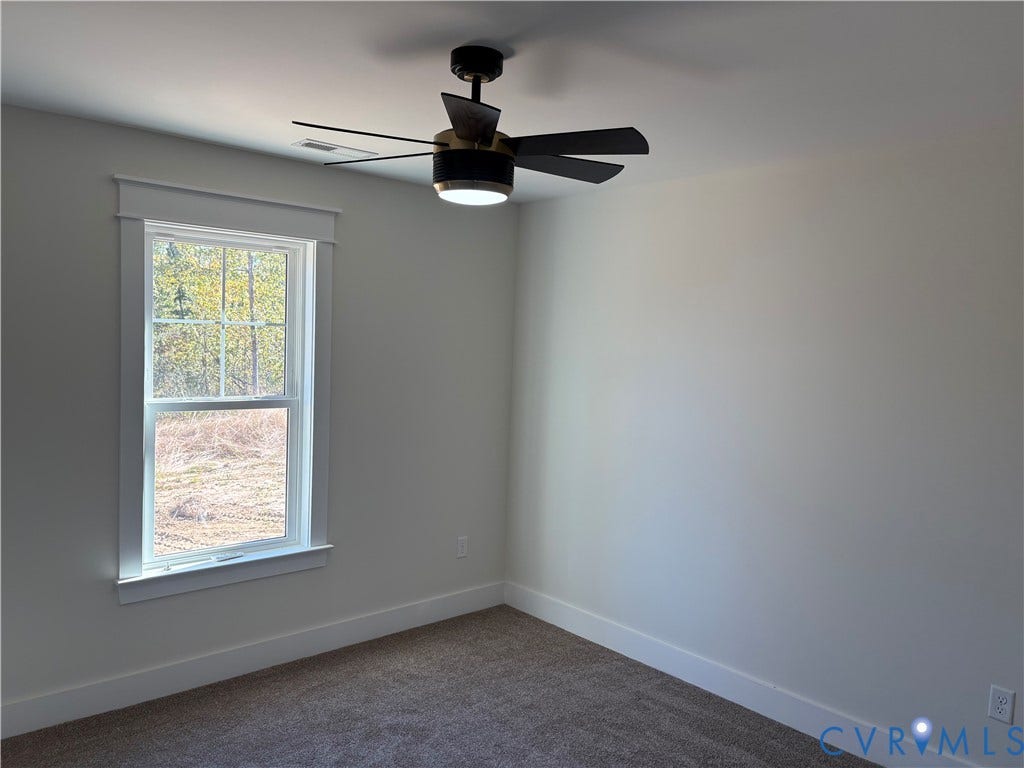 15135 Lebanon, Parson's Retreat, Disputanta, VA 23842 Room featuring neutral wall tones, carpeted flooring, a single-hung window with a header trim, and a modern ceiling fan with an integrated light fixture