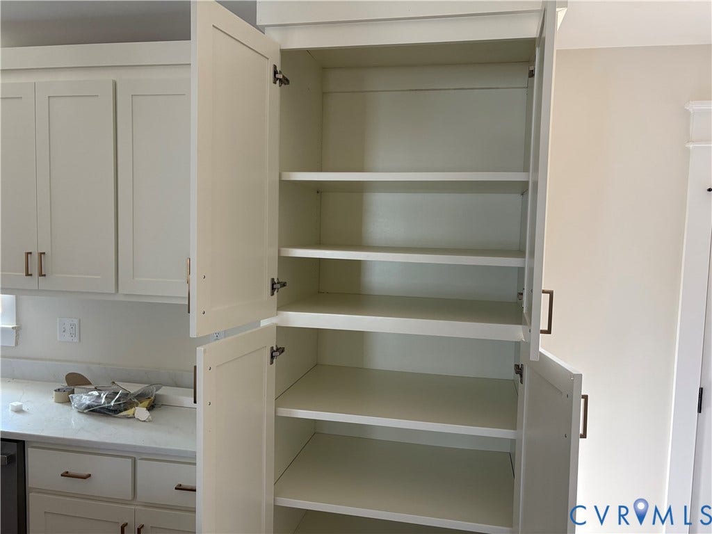 15135 Lebanon, Parson's Retreat, Disputanta, VA 23842 Floor-to-ceiling white cabinetry featuring shaker-style doors, adjustable shelving, and metallic hardware pulls