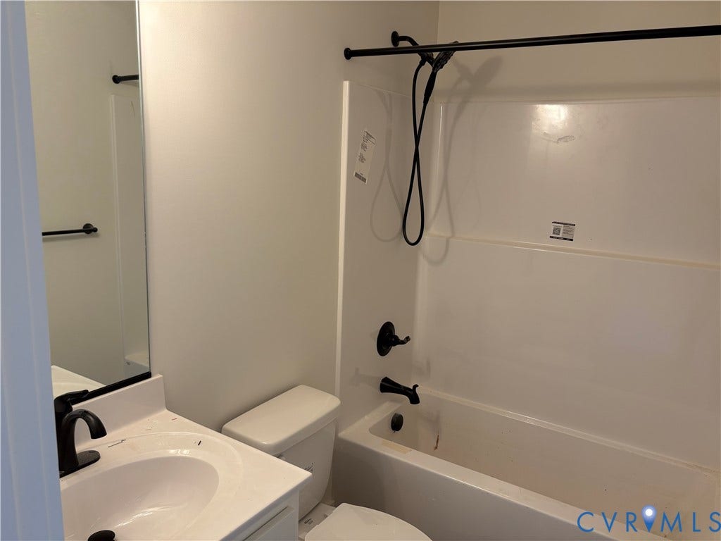 15135 Lebanon, Parson's Retreat, Disputanta, VA 23842 Bathroom featuring a white vanity with a rectangular basin, matte black fixtures, a wall-mounted mirror, and a tub-shower combination with a matte black shower rod