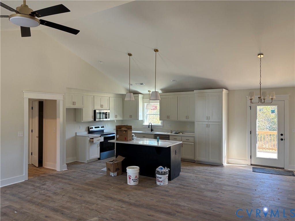15135 Lebanon, Parson's Retreat, Disputanta, VA 23842 Kitchen featuring vaulted ceilings, wood-finish flooring, a central island with a contrasting base, shaker-style cabinetry, and multi-pendant lighting