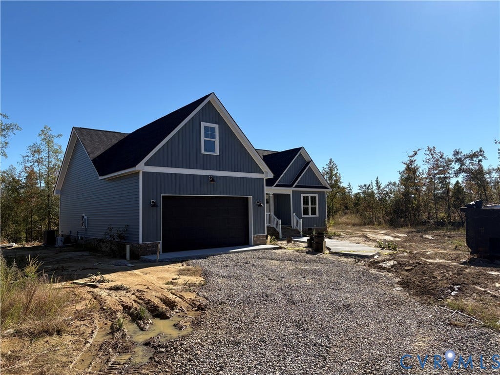 15135 Lebanon, Parson's Retreat, Disputanta, VA 23842 Single-story residence featuring board-and-batten siding, stone foundation trim, a dual-gable roofline, and an attached two-car garage