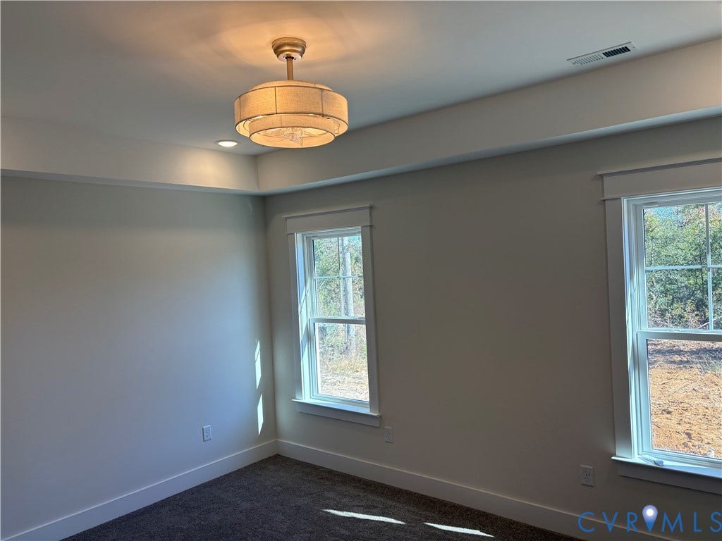 15135 Lebanon, Parson's Retreat, Disputanta, VA 23842 Tray ceiling with recessed lighting, drum-style chandelier, and dual windows with wide-profile casing
