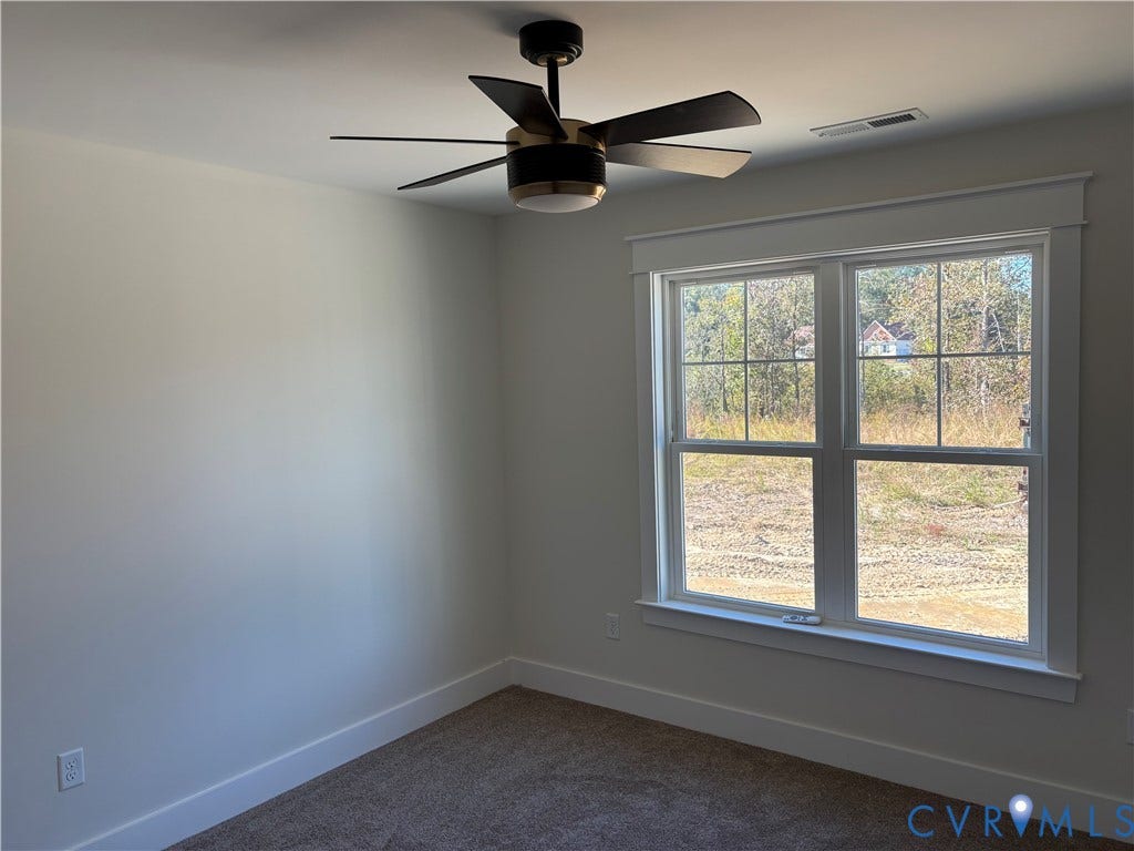 15135 Lebanon, Parson's Retreat, Disputanta, VA 23842 Multi-pane window with detailed trim, neutral wall coloring, and a modern six-blade ceiling fan