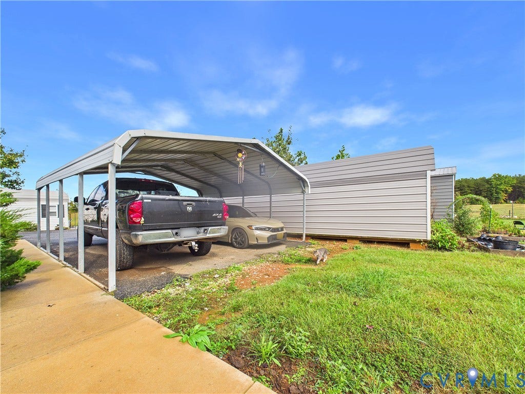 290 Western Lane, Appomattox, Appomattox, VA 24522 Metal carport structure with a concrete pad and an additional metal-sided storage building