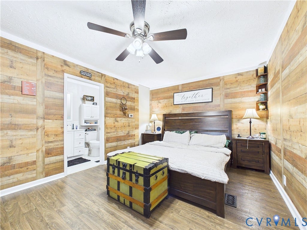 290 Western Lane, Appomattox, Appomattox, VA 24522 Interior space featuring horizontal wood-plank wall treatments, wood-finish flooring, a ceiling fan with integrated lighting, and corner-mounted built-in shelving