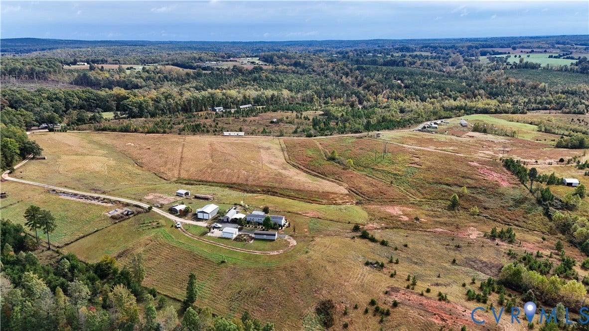 290 Western Lane, Appomattox, Appomattox, VA 24522 Expansive acreage featuring rolling open fields, multiple auxiliary structures, and perimeter woodland