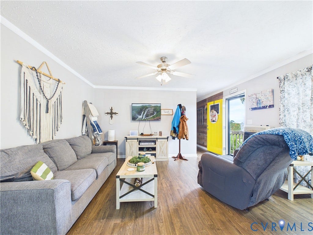 290 Western Lane, Appomattox, Appomattox, VA 24522 Wood-finish flooring, ceiling fan with integrated lighting, textured walls, and wood-paneled accent wall