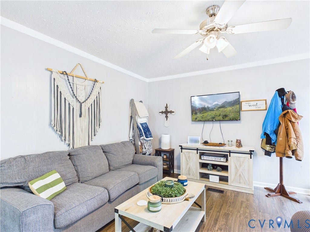 290 Western Lane, Appomattox, Appomattox, VA 24522 Neutral-toned walls featuring crown molding, wood-finish flooring, and a ceiling-mounted light fixture with integrated fan