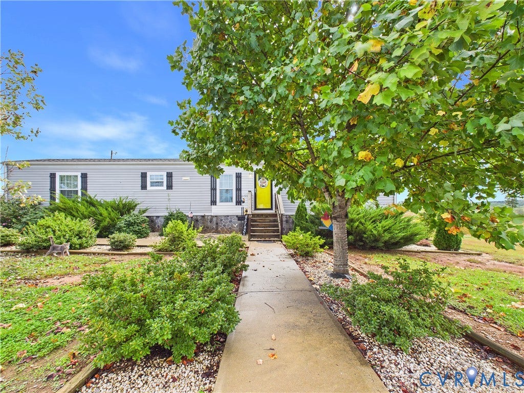 290 Western Lane, Appomattox, Appomattox, VA 24522 Exterior featuring light gray horizontal siding, shuttered windows, concrete walkway, and landscaped grounds with mature trees
