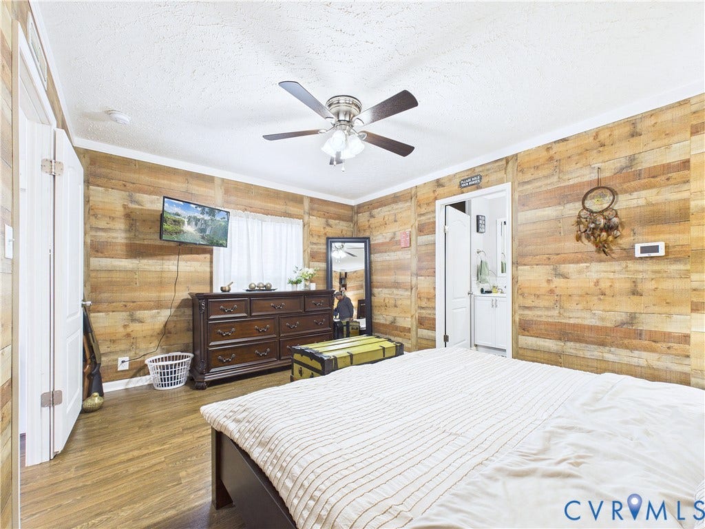 290 Western Lane, Appomattox, Appomattox, VA 24522 Horizontal wood-plank wall paneling, wood-finish flooring, and a ceiling fan with integrated lighting