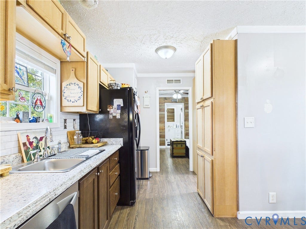 290 Western Lane, Appomattox, Appomattox, VA 24522 Kitchen featuring wood-finish cabinetry, stone-patterned countertops, a white subway tile backsplash, a dual-basin stainless steel sink with a chrome gooseneck faucet, and wood-finish flooring