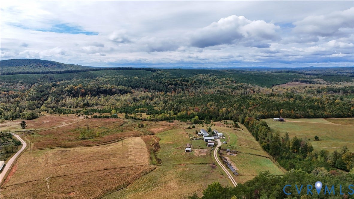 290 Western Lane, Appomattox, Appomattox, VA 24522 Aerial perspective of expansive acreage featuring open pasture, mature woodland, natural topography, and a private gravel drive
