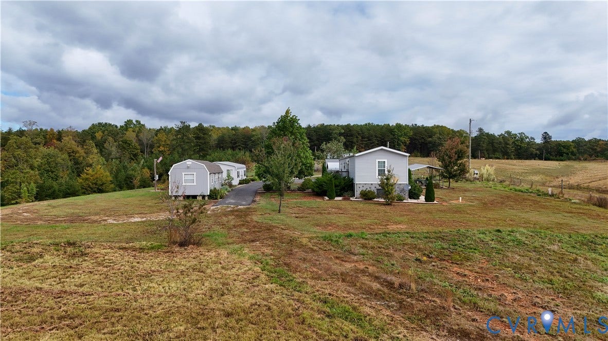 290 Western Lane, Appomattox, Appomattox, VA 24522 Expansive acreage featuring a paved driveway, detached storage structure, and stone-finish foundation detailing