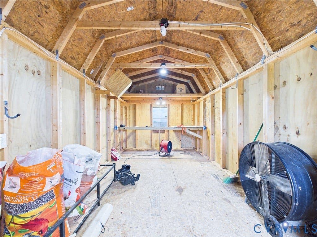 290 Western Lane, Appomattox, Appomattox, VA 24522 Storage structure featuring exposed wood framing, plywood wall paneling, a gambrel roof design, built-in shelving, and a single window