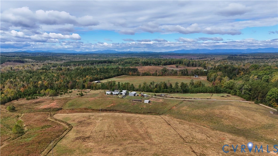 290 Western Lane, Appomattox, Appomattox, VA 24522 Expansive acreage featuring rolling meadows, multi-structure site, unpaved access paths, and mountain backdrop