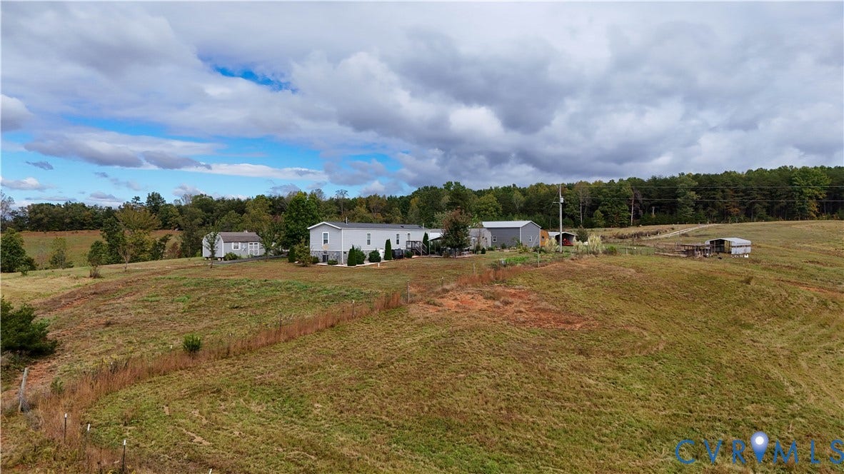 290 Western Lane, Appomattox, Appomattox, VA 24522 Expansive acreage featuring rolling terrain, open pasture, mature tree lines, and multiple outbuildings