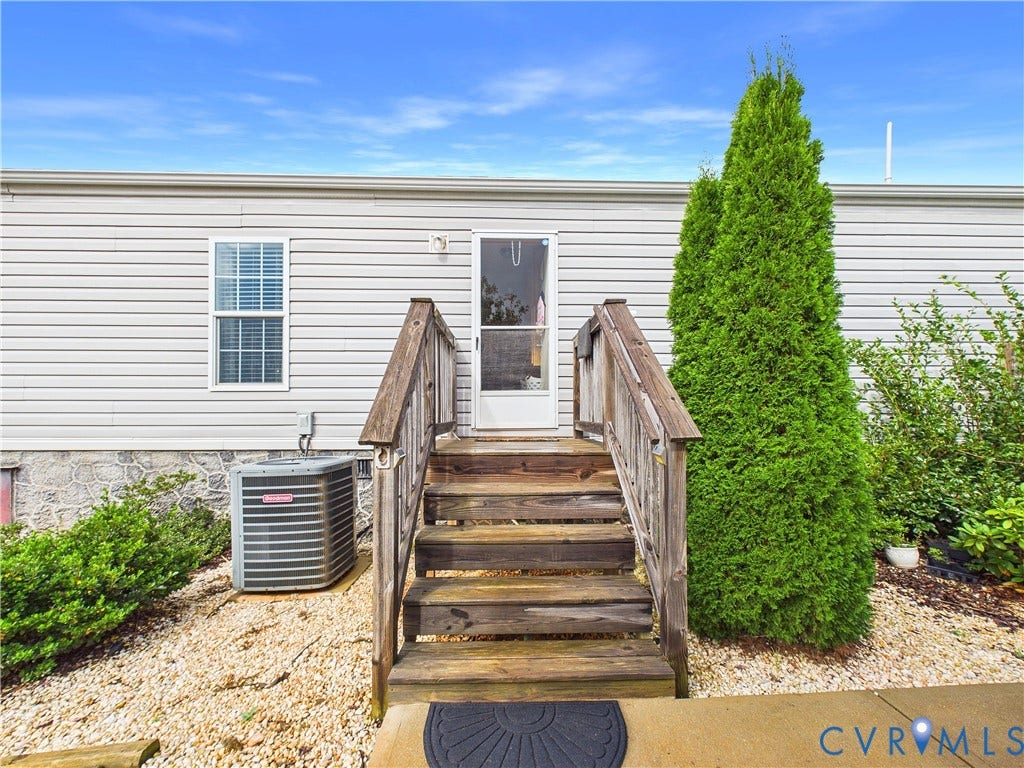 290 Western Lane, Appomattox, Appomattox, VA 24522 Exterior featuring light-colored horizontal siding, a stone-finish foundation, wooden staircase with matching handrails, and a central entry door with a screen