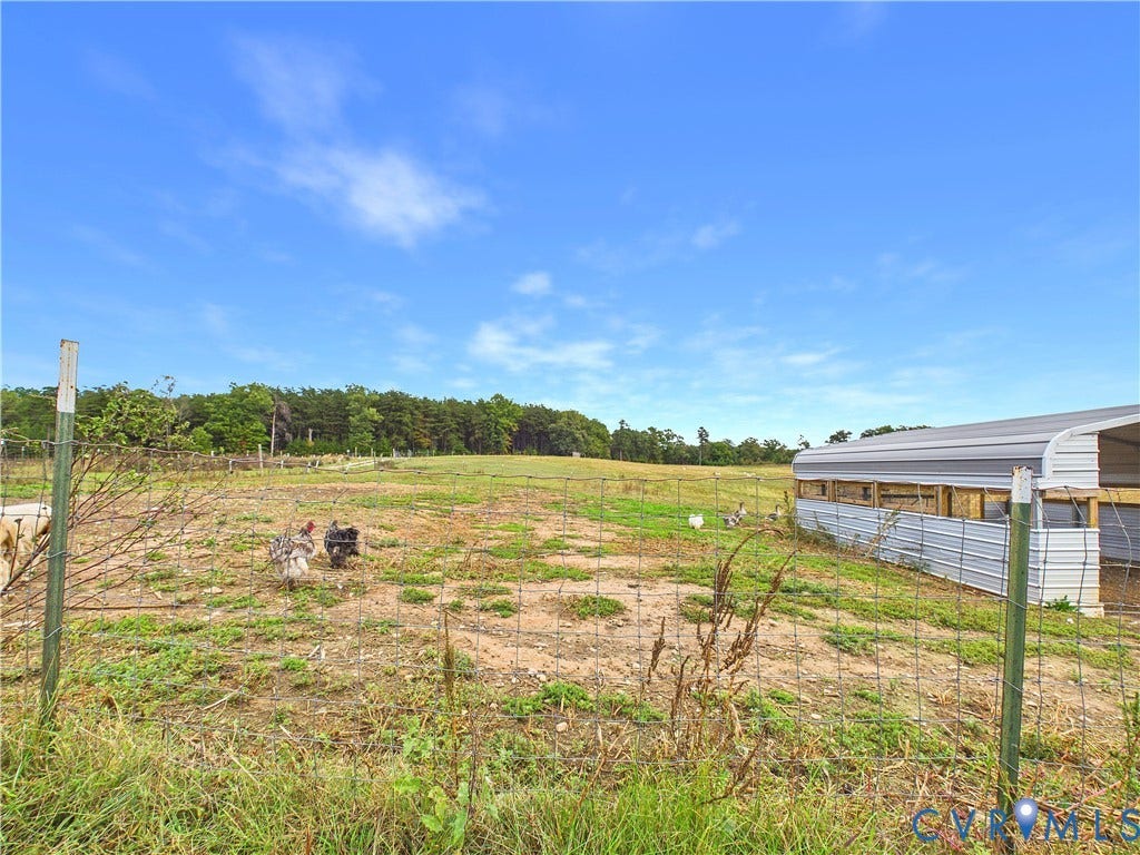 290 Western Lane, Appomattox, Appomattox, VA 24522 Open acreage featuring a wire perimeter fence and a metal-sided utility structure