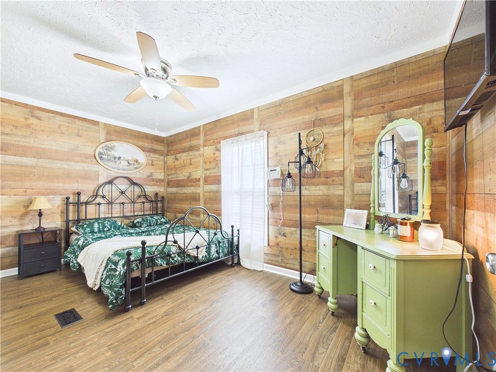 290 Western Lane, Appomattox, Appomattox, VA 24522 Horizontal wood plank wall paneling, wood-finish flooring, and a central ceiling fan with integrated lighting
