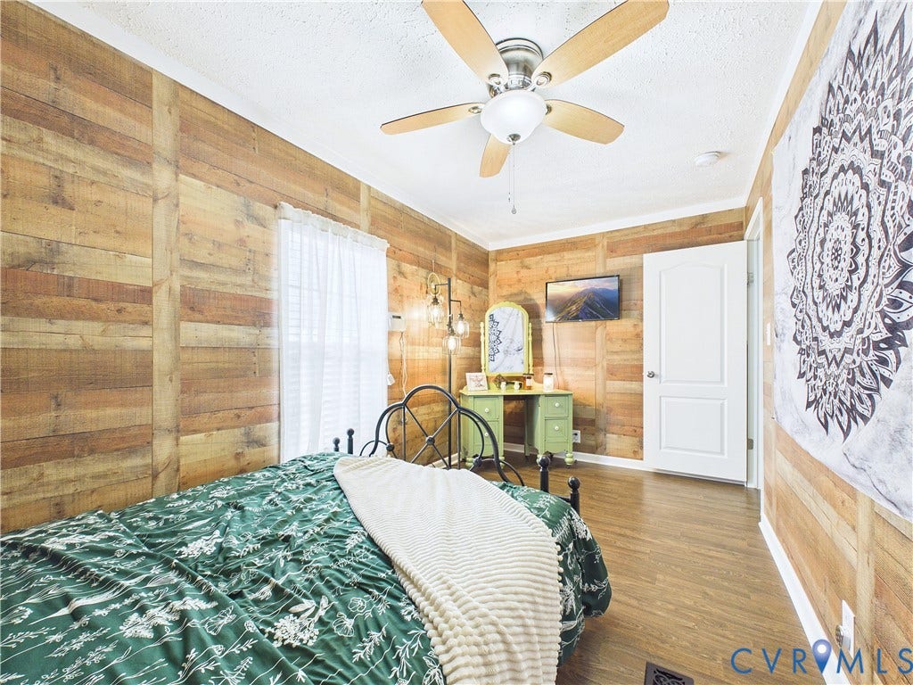 290 Western Lane, Appomattox, Appomattox, VA 24522 Wood-plank wall paneling, wood-finish flooring, and a multi-blade ceiling fan with an integrated light fixture
