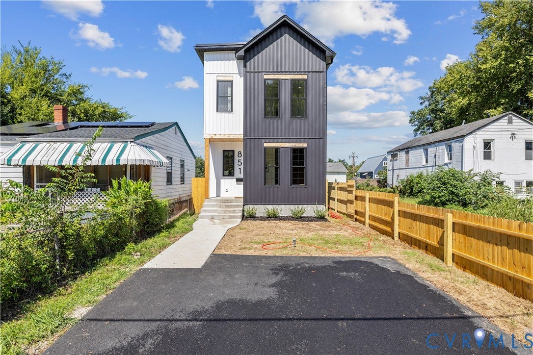 851 E Bank Street, Old Towne, Petersburg, VA 23803 Two-story residence featuring vertical metal panel siding, a covered entryway with concrete steps, and a private asphalt driveway