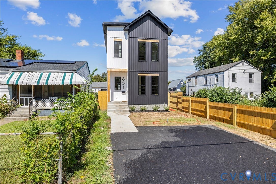 851 E Bank Street, Old Towne, Petersburg, VA 23803 Modern two-story exterior featuring vertical metal siding, high-contrast black and white color palette, concrete entryway steps, and an asphalt driveway