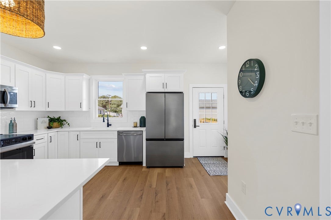 851 E Bank Street, Old Towne, Petersburg, VA 23803 Kitchen featuring white cabinetry, wood-finish flooring, stainless steel appliances, quartz countertops, and a single-light glass panel exterior door