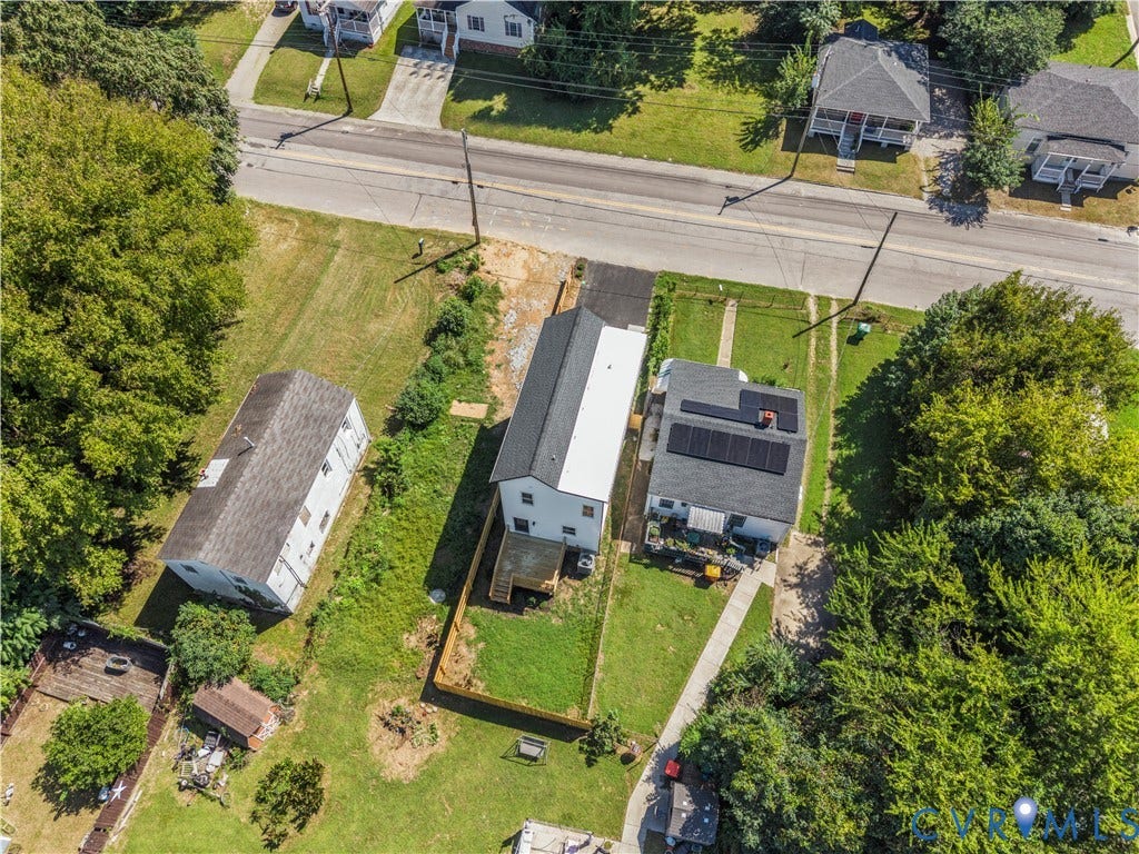 851 E Bank Street, Old Towne, Petersburg, VA 23803 Aerial view of a residential lot featuring a multi-level deck, fenced rear yard, solar panel installation, asphalt driveway, and mature landscaping