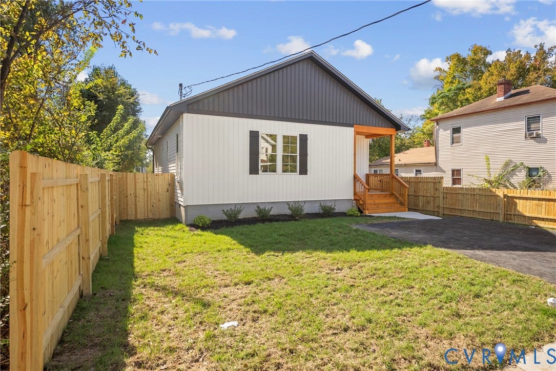 1420 Ferndale Avenue, Petersburg, VA 23803 Exterior featuring dual-tone vertical siding, natural wood front porch, asphalt driveway, and perimeter wood privacy fencing