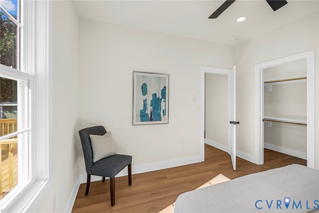 1420 Ferndale Avenue, Petersburg, VA 23803 Neutral-toned walls featuring wood-finish flooring, a multi-pane window, a ceiling fan, and a walk-in closet with built-in shelving