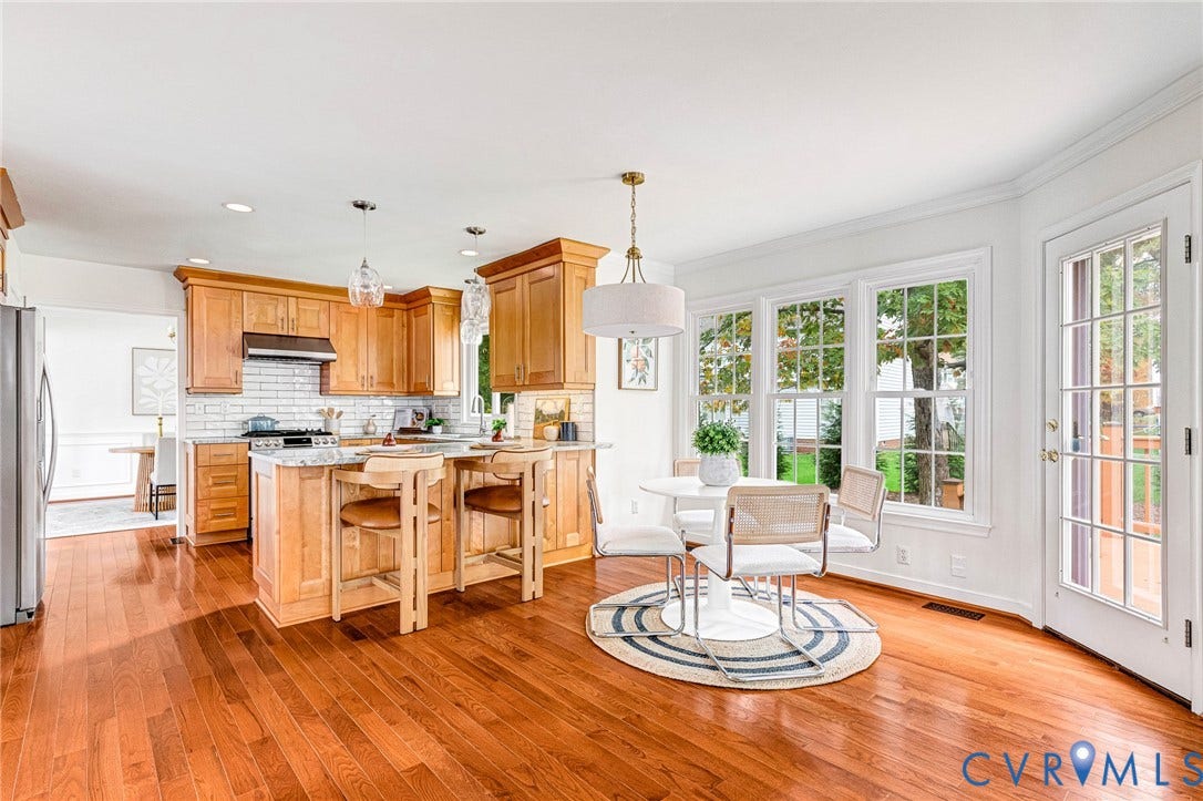 3629 Milbury Run Street, Henrico, VA 23233 Kitchen featuring wood cabinetry, stone countertops, a subway tile backsplash, wood-finish flooring, and a glass-paneled exterior door