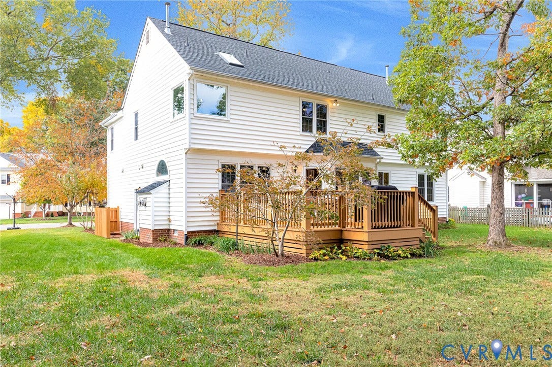 3629 Milbury Run Street, Henrico, VA 23233 Exterior rear elevation featuring white siding, a multi-level wood deck, a skylight, and an expansive lawn