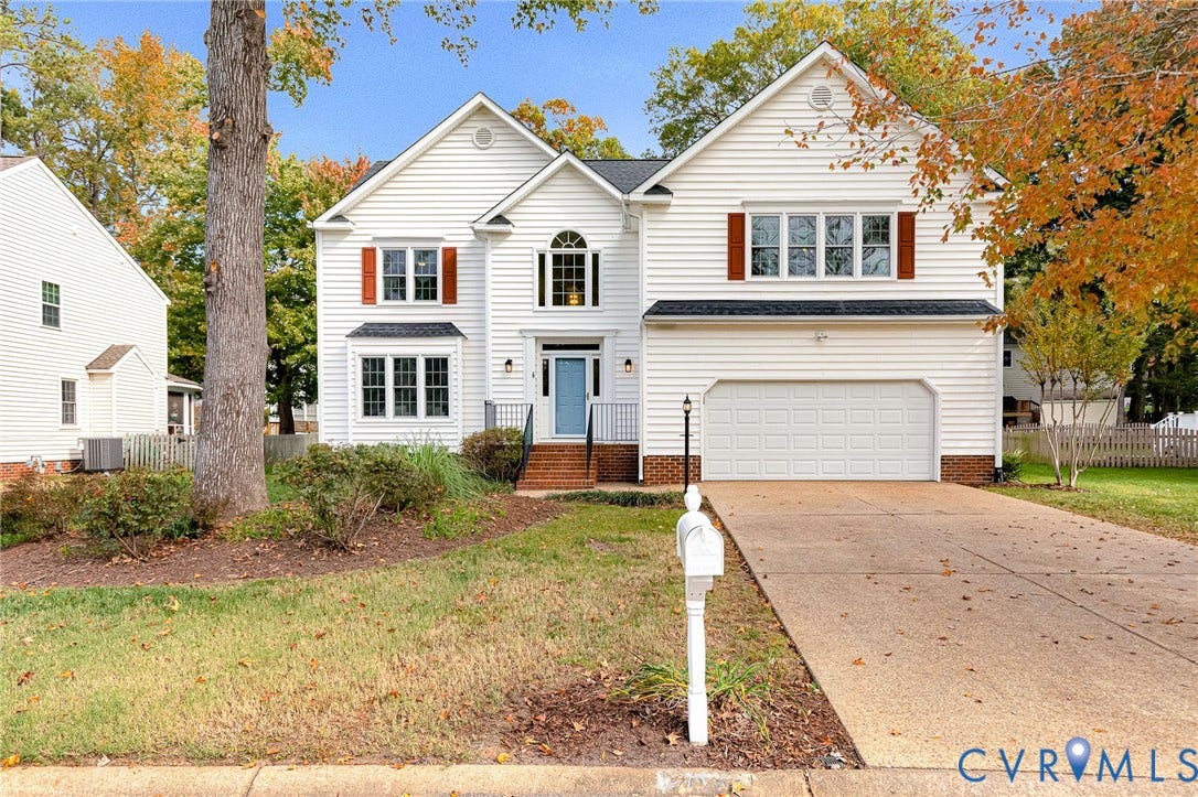 3629 Milbury Run Street, Henrico, VA 23233 Two-story traditional exterior featuring white horizontal siding, brick foundation detailing, multi-pane windows with decorative shutters, and an attached two-car garage