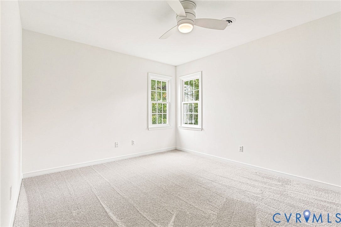 3629 Milbury Run Street, Henrico, VA 23233 Neutral-toned interior featuring wall-to-wall carpeting, dual double-hung windows, and a flush-mount ceiling fan with integrated lighting