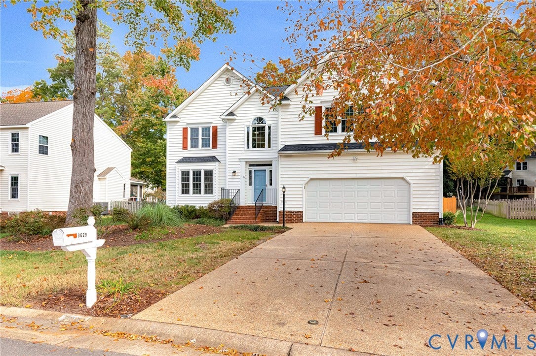 3629 Milbury Run Street, Henrico, VA 23233 Two-story residence featuring white horizontal siding, contrasting shutters, arched window accents, a front-facing attached garage, and a concrete driveway
