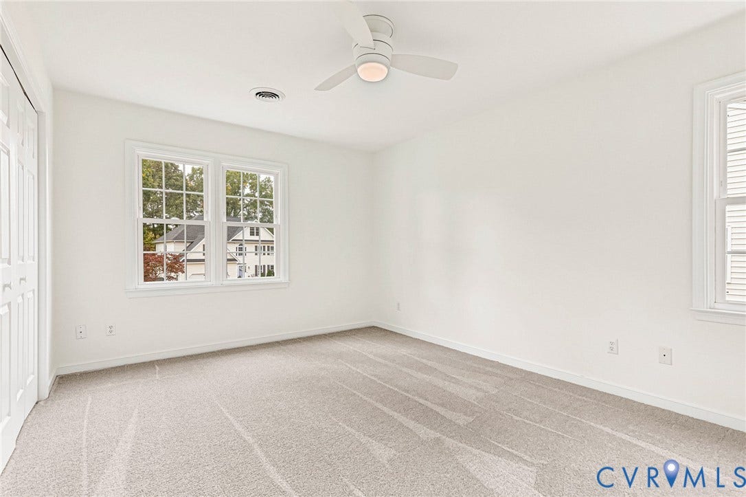 3629 Milbury Run Street, Henrico, VA 23233 Neutral interior featuring neutral carpeting, crisp white wall finishes, multi-pane windows, and a central ceiling fan with an integrated light fixture