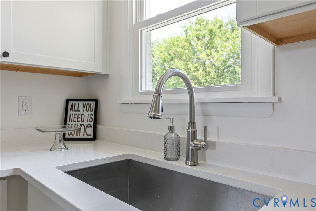 1809 Sussex Street, Whitcomb, Richmond, VA 23223 Stainless steel undermount kitchen sink featuring a brushed nickel high-arc pull-down faucet, quartz countertop, and white shaker-style cabinetry