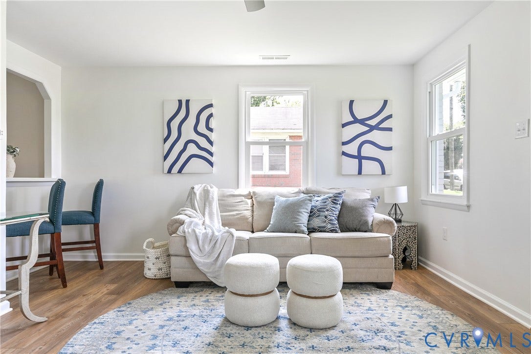 1809 Sussex Street, Whitcomb, Richmond, VA 23223 Living space featuring wood-finish flooring, crisp neutral wall paint, and multiple double-hung windows providing natural light