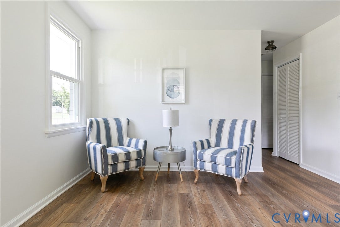1809 Sussex Street, Whitcomb, Richmond, VA 23223 Bright room featuring wood-finish flooring, a double-hung window, and a louvered closet door
