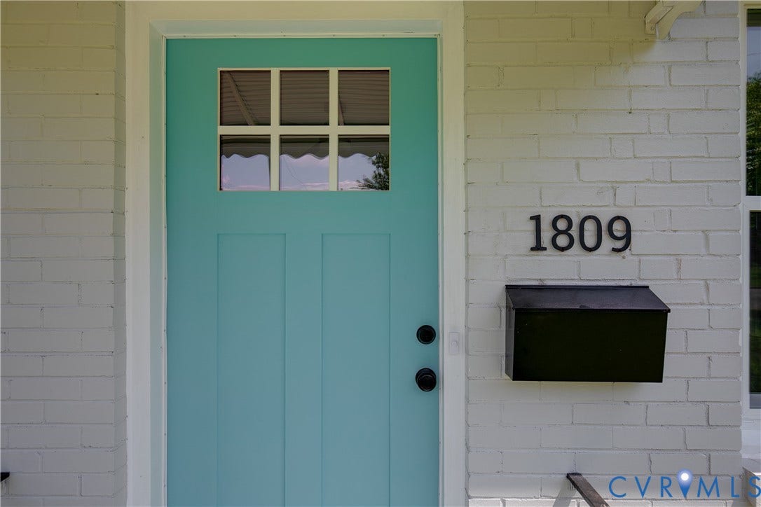 1809 Sussex Street, Whitcomb, Richmond, VA 23223 White painted brick exterior featuring a teal-colored entry door with a six-pane window insert, black matte hardware, and a matching black wall-mounted mailbox