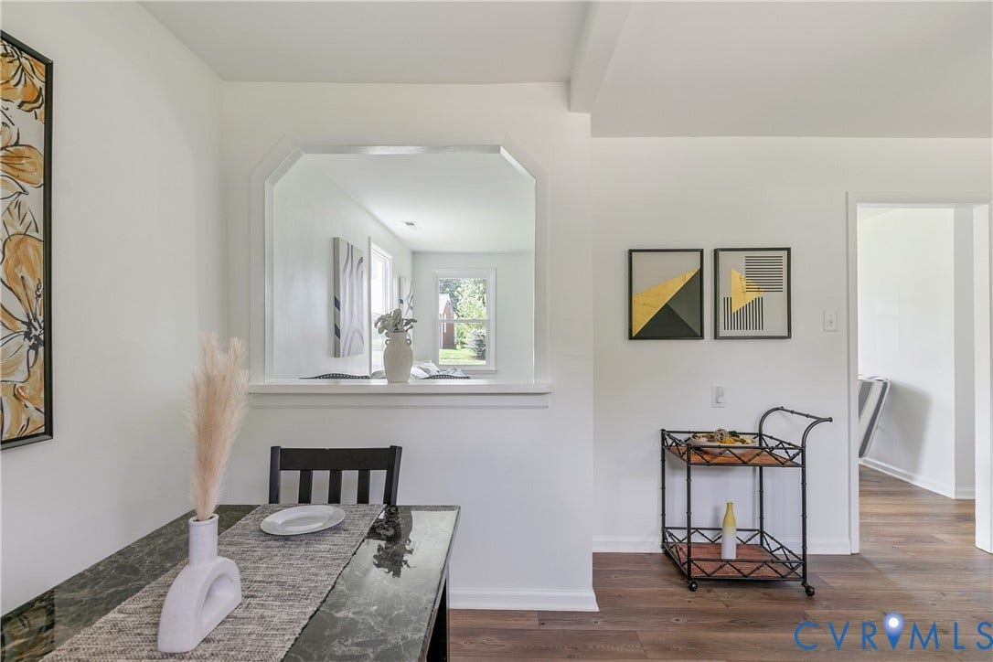 1809 Sussex Street, Whitcomb, Richmond, VA 23223 Interior space featuring wood-finish flooring, a pass-through window with millwork trim, and neutral wall tones