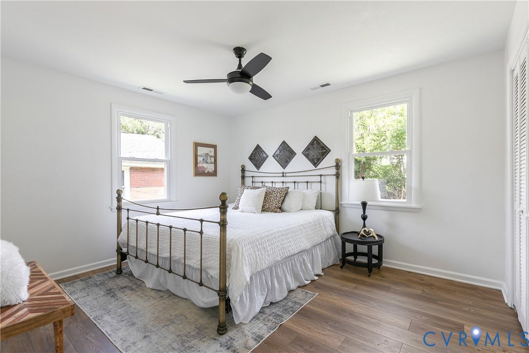 1809 Sussex Street, Whitcomb, Richmond, VA 23223 Room with wood-finish flooring, dual windows with white trim, matte black ceiling fan with integrated lighting, and louvered closet doors