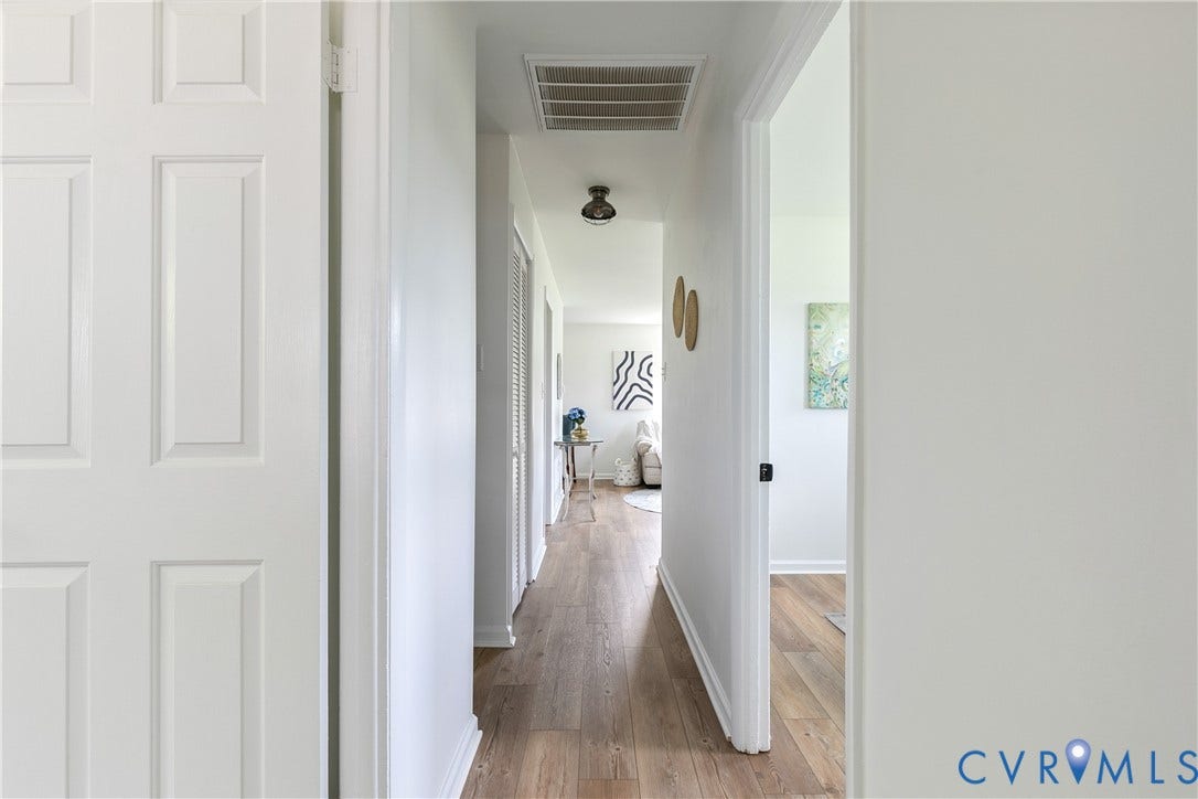 1809 Sussex Street, Whitcomb, Richmond, VA 23223 Interior hallway featuring wood-finish flooring, six-panel interior doors, and a ceiling-mounted light fixture