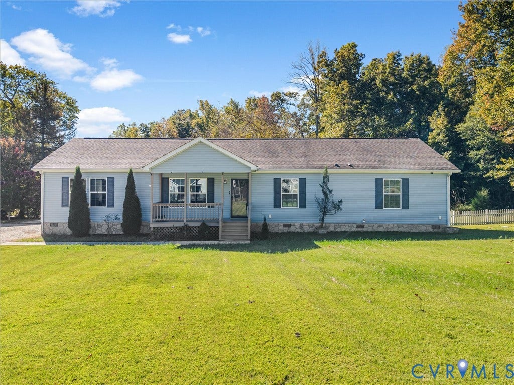 1625 Cedar Lane, Powhatan, VA 23139 Ranch-style exterior featuring light blue horizontal siding, a stone-veneer foundation, a front-facing porch with wooden railing, shutters, and an expansive lawn