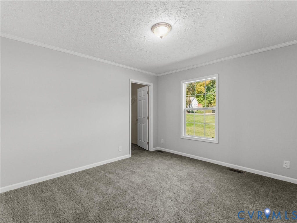 1625 Cedar Lane, Powhatan, VA 23139 Neutral-toned walls, wall-to-wall carpeting, window with pane detailing, and a flush-mount ceiling light fixture