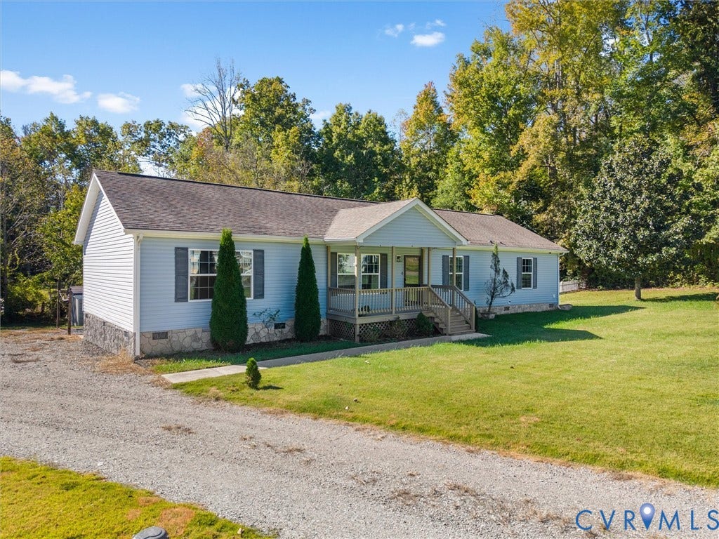 1625 Cedar Lane, Powhatan, VA 23139 Ranch-style exterior featuring light-toned siding, a stone veneer foundation, a covered front porch with railings, and a gravel driveway