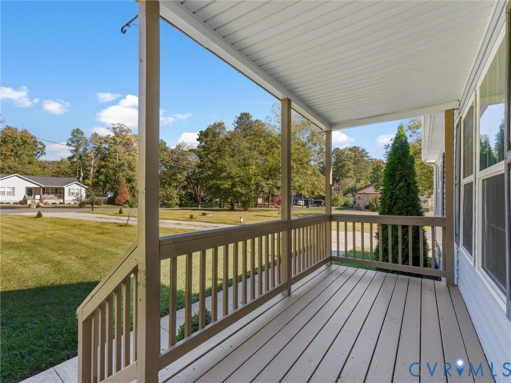 1625 Cedar Lane, Powhatan, VA 23139 Covered front porch featuring wood-plank flooring, painted railing, and overhead beadboard paneling