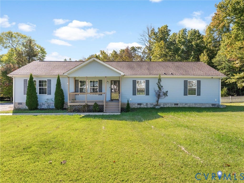 1625 Cedar Lane, Powhatan, VA 23139 Single-story residence featuring horizontal vinyl siding, a stone-veneer foundation, a covered front porch with a wood railing, and a gabled entryway